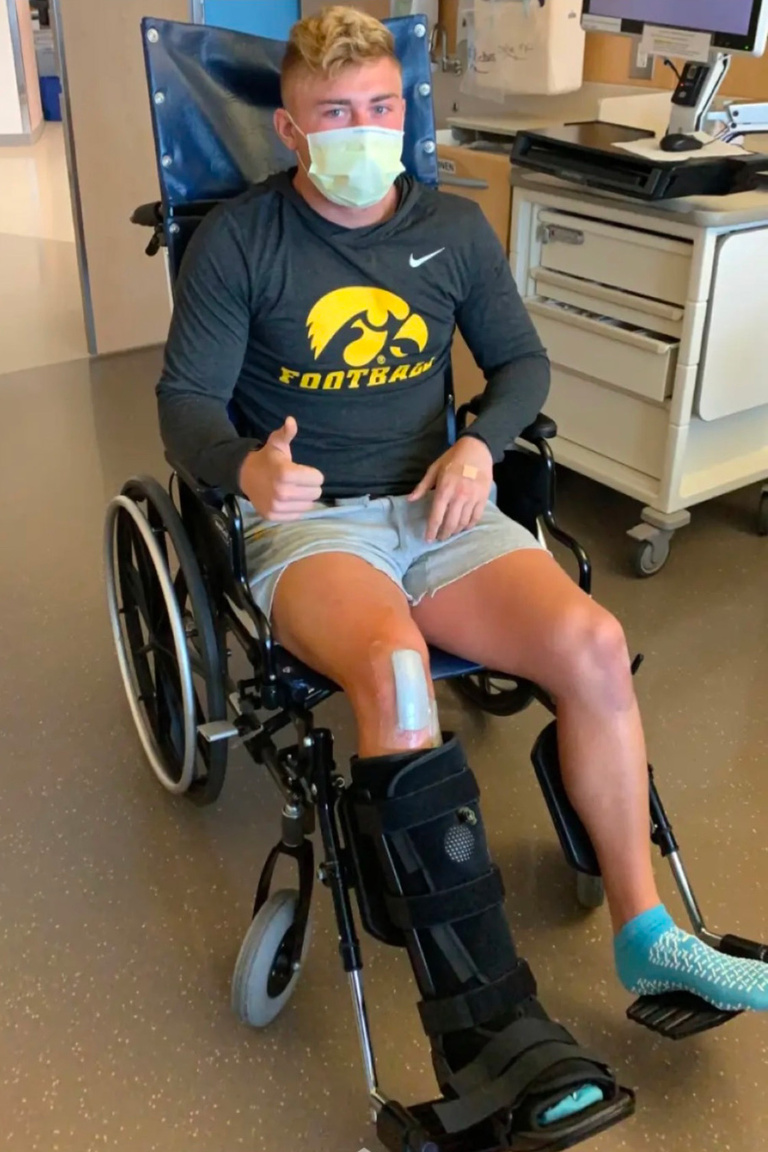 Nick Phelps giving a thumbs-up while sitting in a wheelchair
