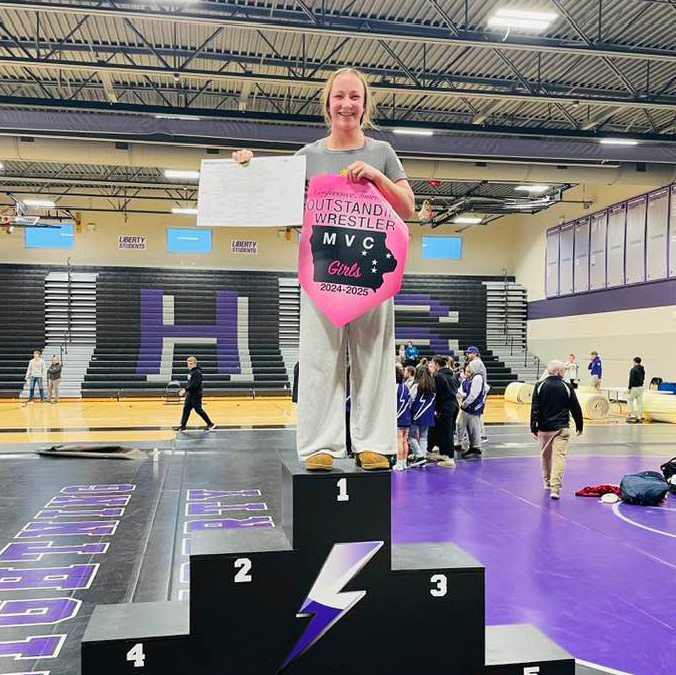 Eve Skrocki atop a podium