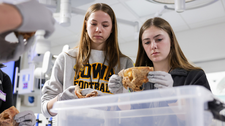 two students examine samples at a Teens Go STEM event