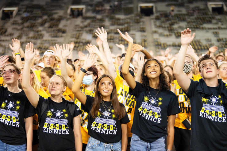 new University of Iowa students waving during the Kickoff at Kinnick event