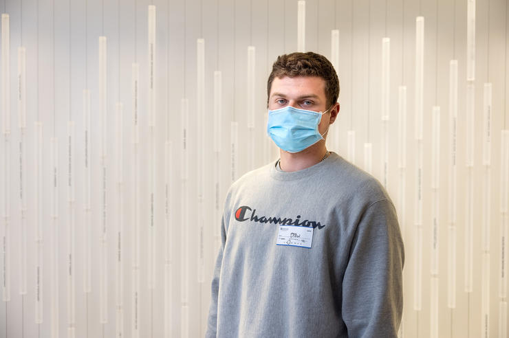 a man stands in the corridor of a health care facility