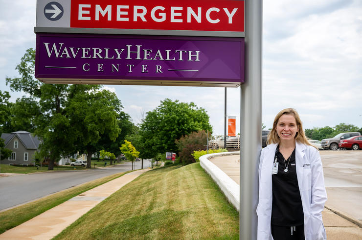 University of Iowa Carver College of Medicine grad Emily Boevers standing outside a medial facility in Waverly, Iowa