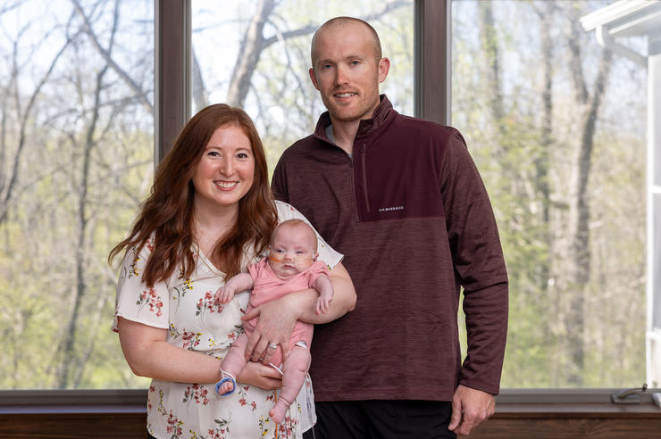 Emily and Ted Eilers hold their daughter Evelyn at their home