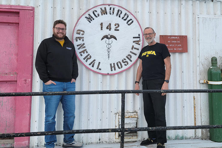 two university of Iowa medicine alums stand at a research station in antarctica