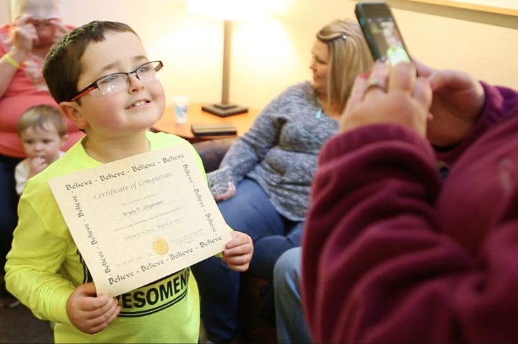brady jorgensen, a patient at university of iowa stead family children's hospital, holds a certificate of completion