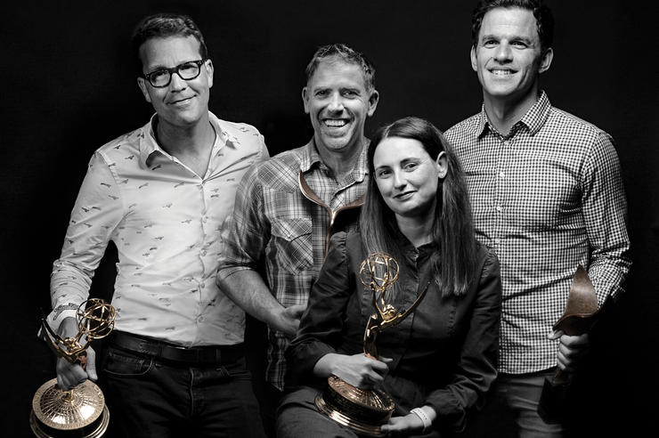 the four writers of Castle Rock pose together for a photo, two of them holding award statues