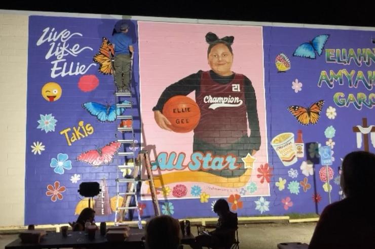 Abel Ortiz-Acosta paints a mural dedicated to Eliahna “Ellie” Garcia, who was killed in a shooting at at Robb Elementary School in Uvalde, Texas.