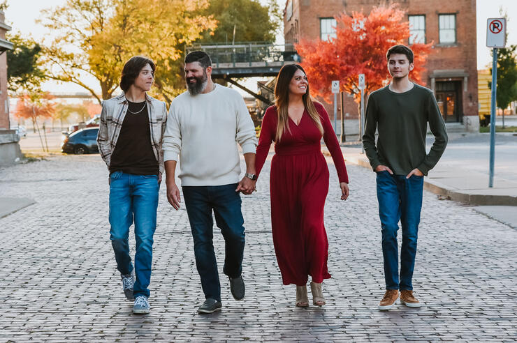 a family of four walking down a street