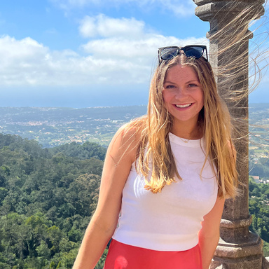 University of Iowa med student Reese Rosenmeyer standing in a mountainous setting