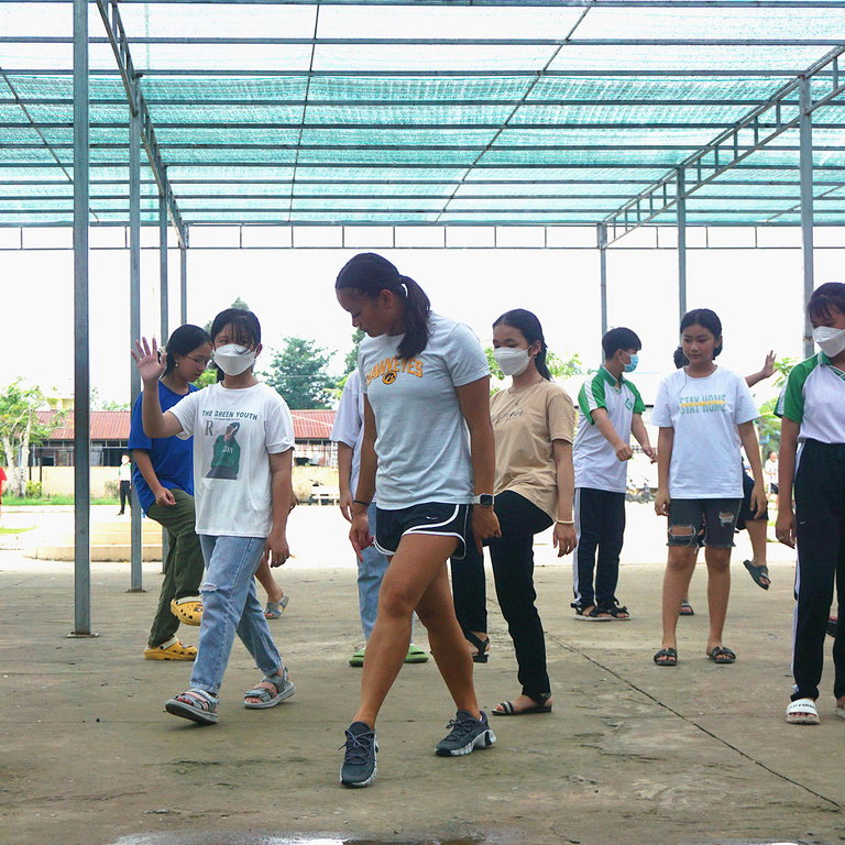 A teacher demonstrating a dance move