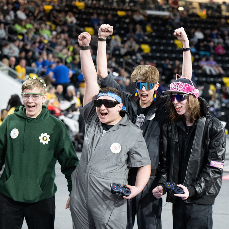people cheering with their arms in the air