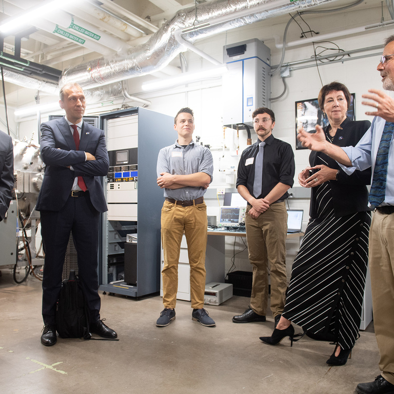 A group of people talking in a lab