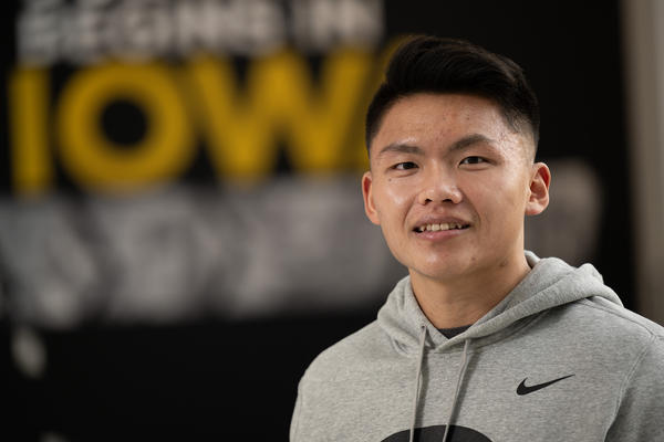 University of Iowa graduate Kevin Dong standing outside the College of Pharmacy