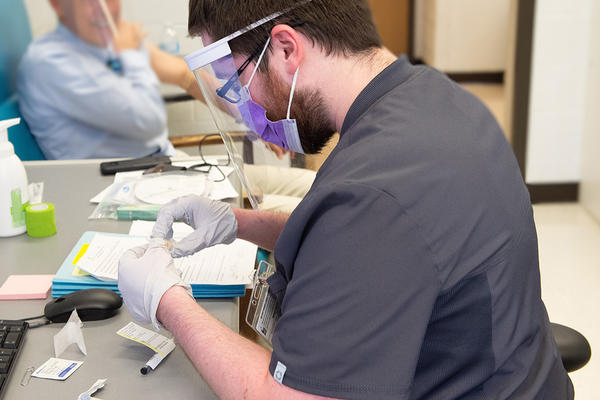 A University of Iowa employee in a medical setting