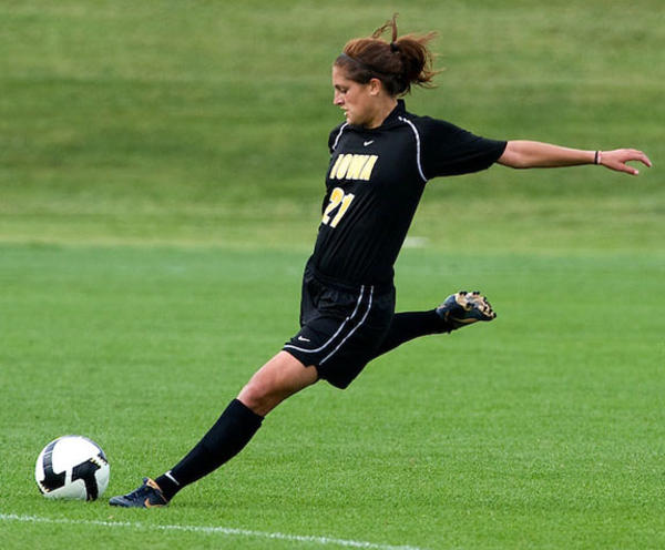 University of Iowa women's soccer player about to kick a ball