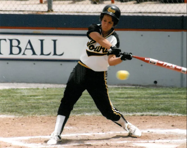 softball player swinging at a pitch