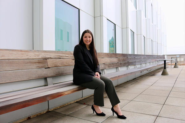 University of Iowa spring 2023 graduate Mara Frieden sitting on a bench