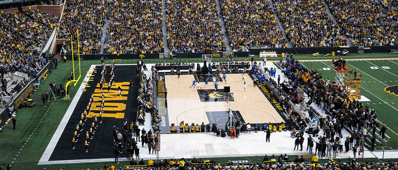 a women's basketball game played outdoors at Kinnick Stadium