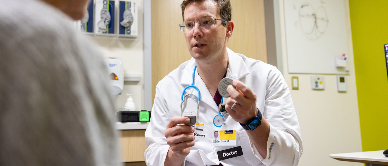  a doctor holding up a medical device 
