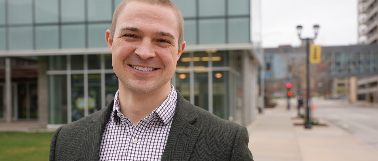 A man standing outside smiling