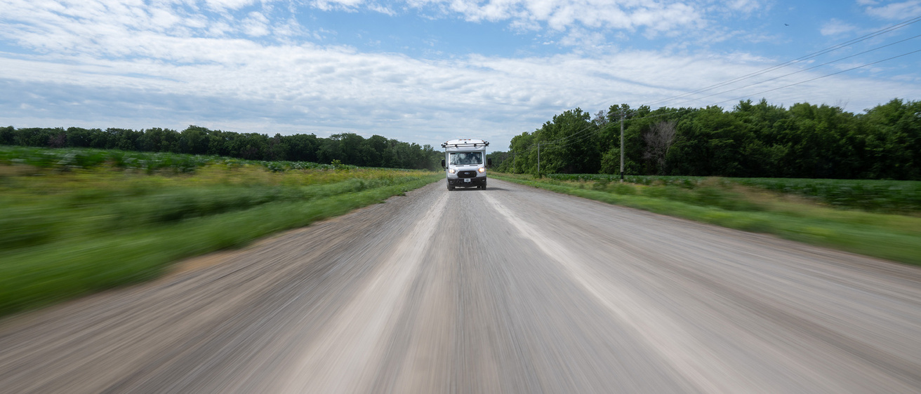 A distant shot of a car driving on a road