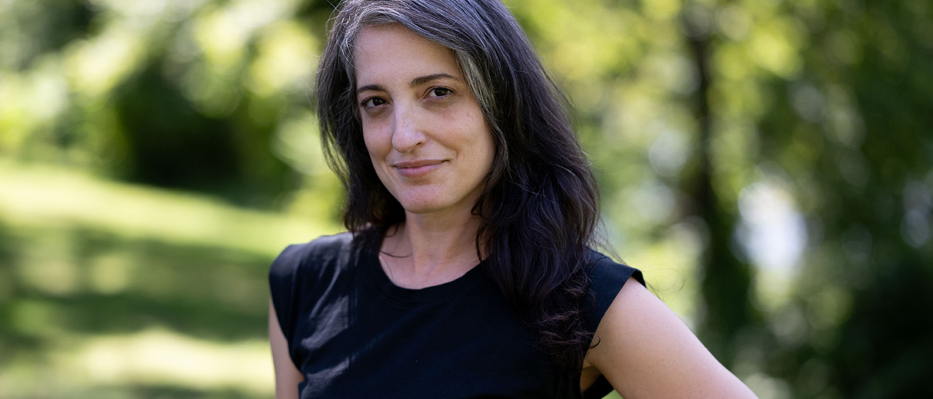 A woman posing for a photo with her hand on her hip