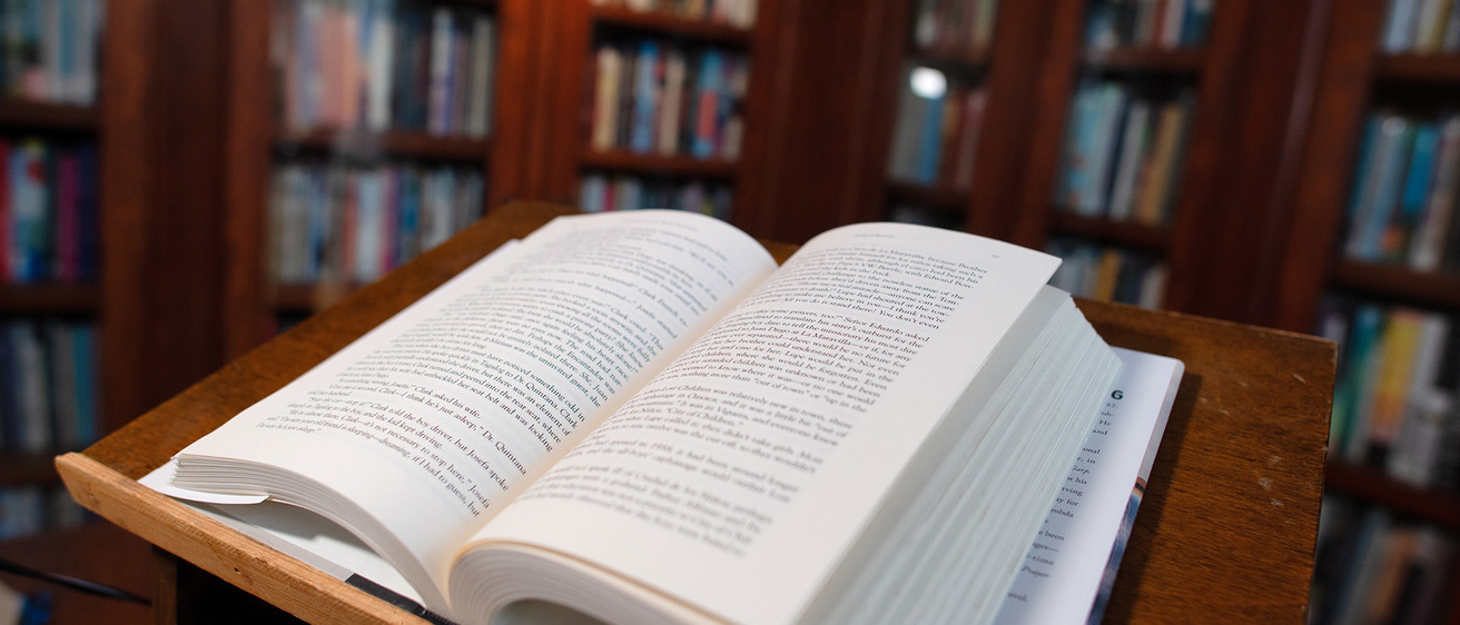 An open book sitting on a lectern