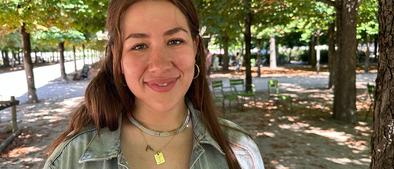 a portrait of a woman on a shaded pedestrian mall