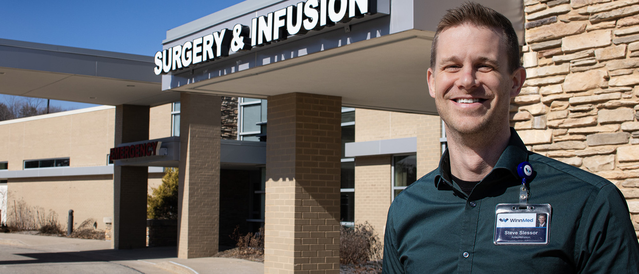 A man standing in front of an emergency room
