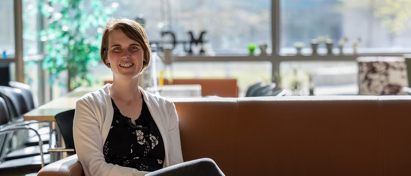 A woman sitting on a couch and smiling