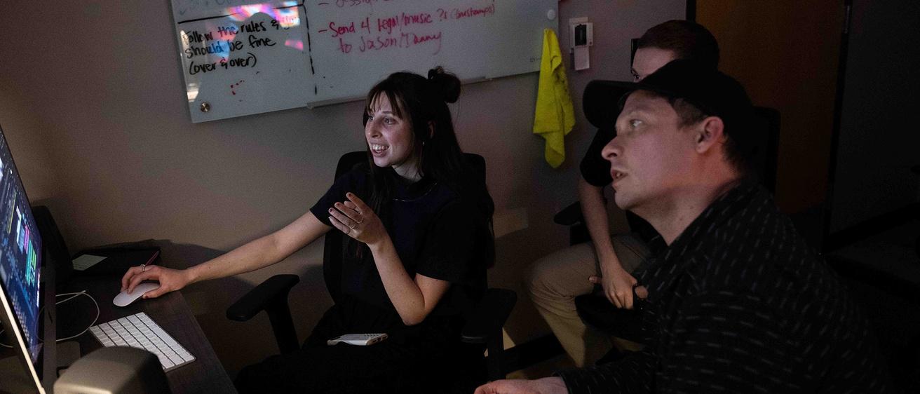 a group of people sitting behind a computer