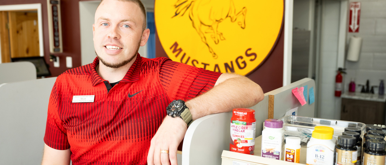 A man leaning on a counter and smiling
