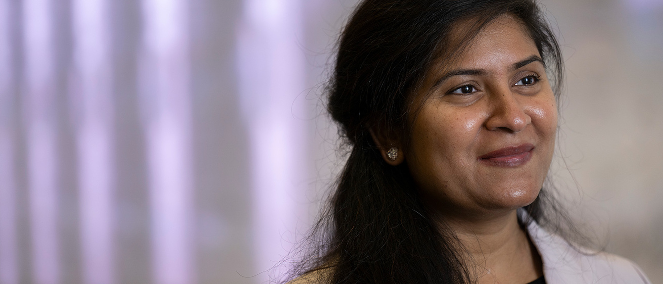A woman smiling towards the distance