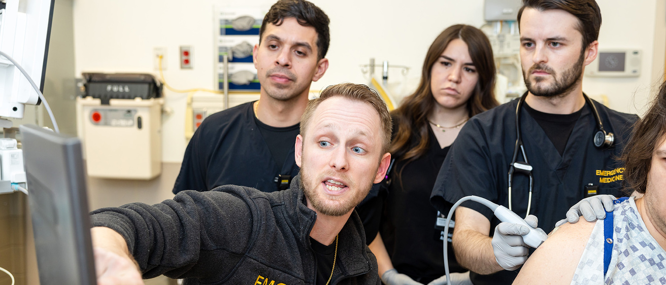 Emergency medicine physician assistant residents with simulated patient and Christian Junker, PA-C