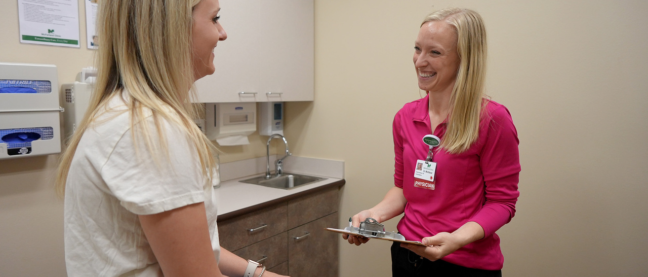 A physician talking to her patient