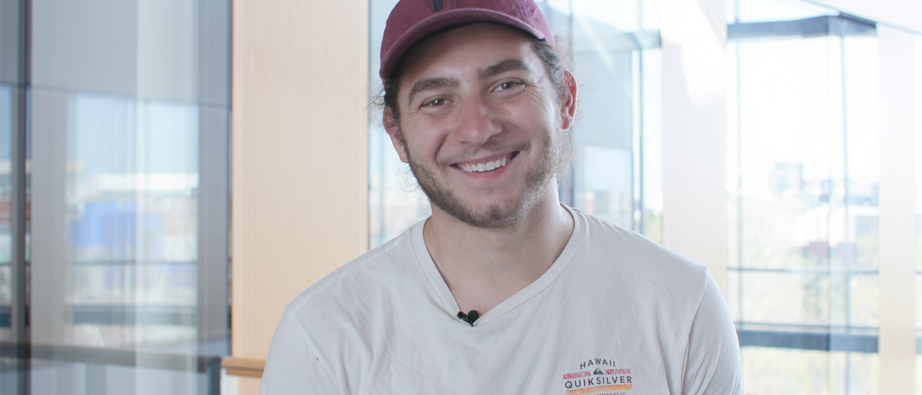 A man standing in front of a window and smiling