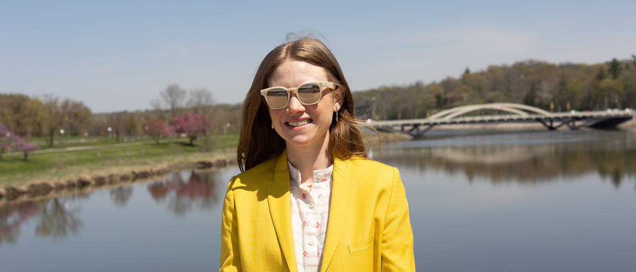 A woman standing on a bridge and smiling