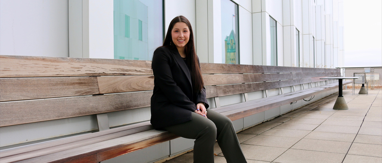 A woman sitting on a bench outside