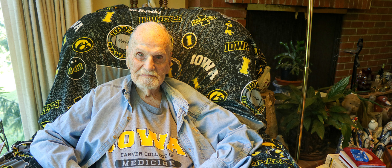 A man sitting in an Iowa themed chair