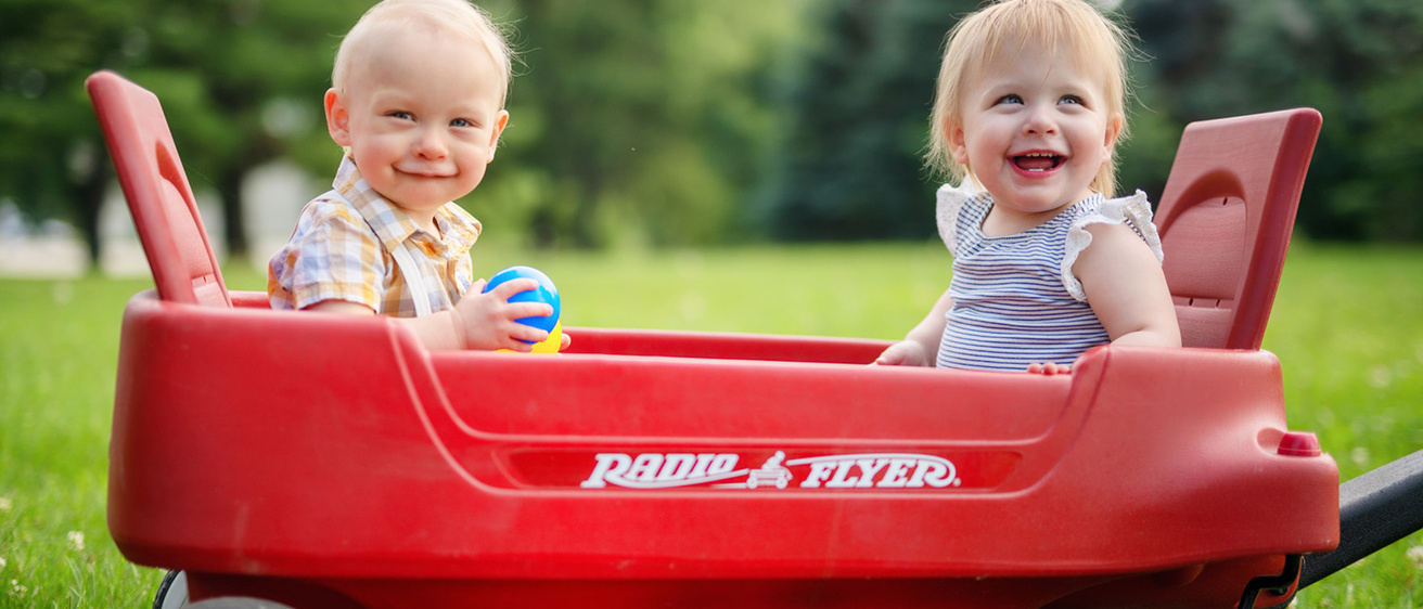 two children sitting in a wagon