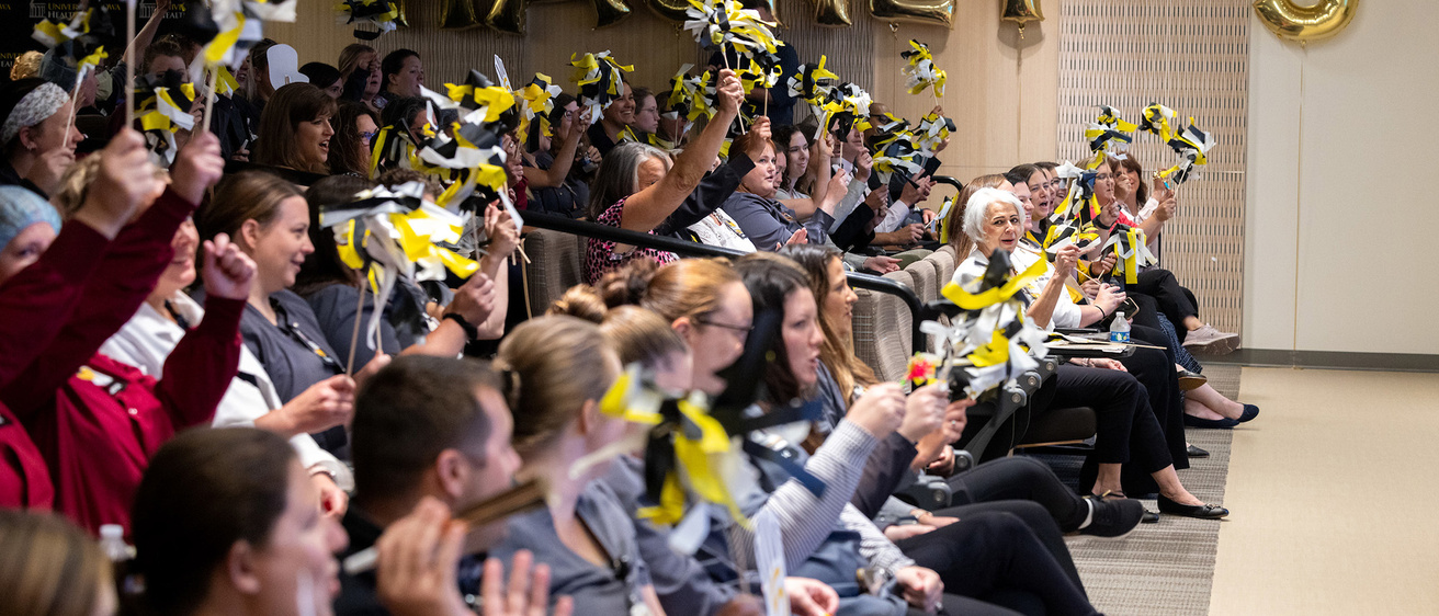 A crowd of people cheering together