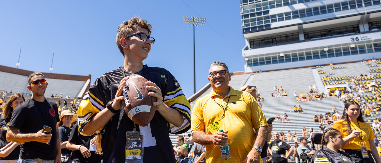 A boy holding a football
