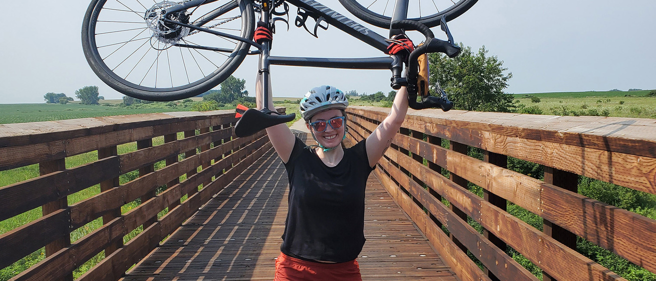 a woman holding a bicycle in the air