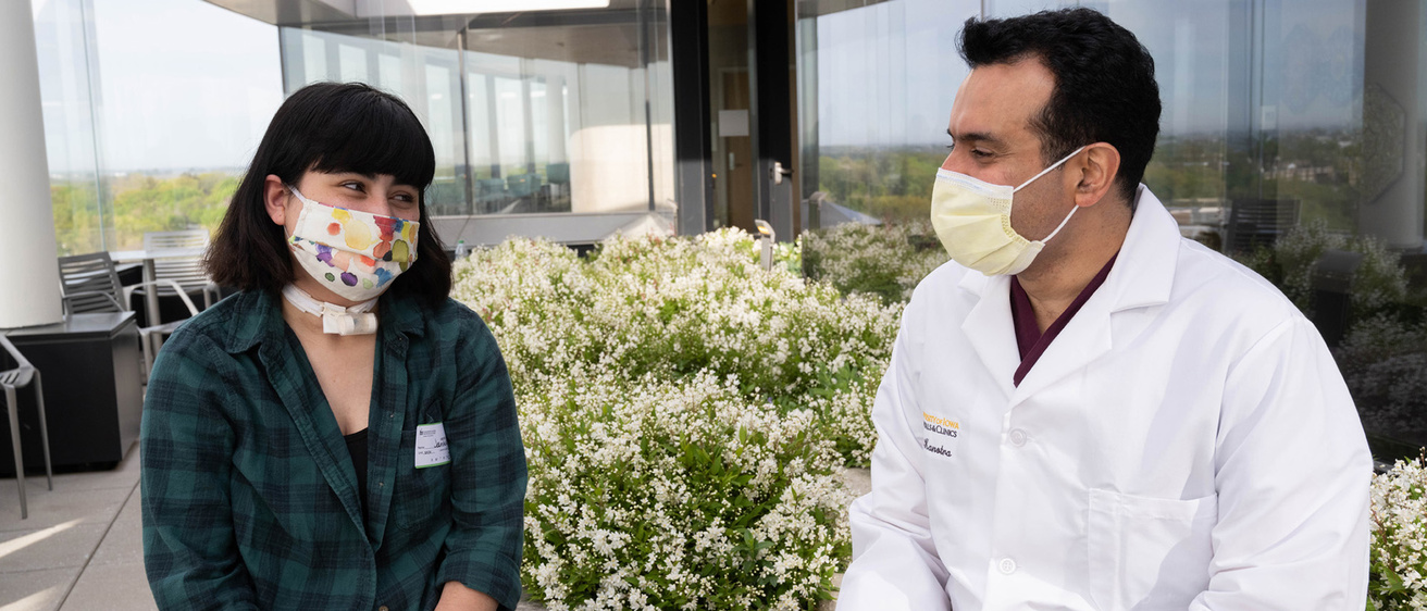 a doctor sits outside with a young patient