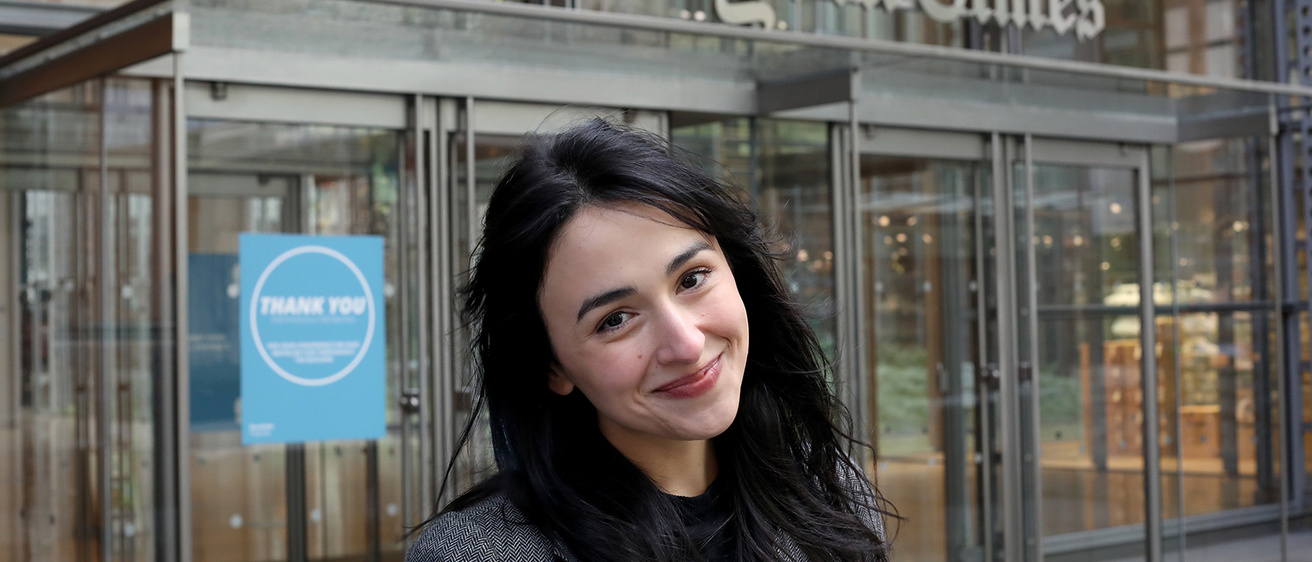 Asmaa Elkeurti standing in front of the New York Times building