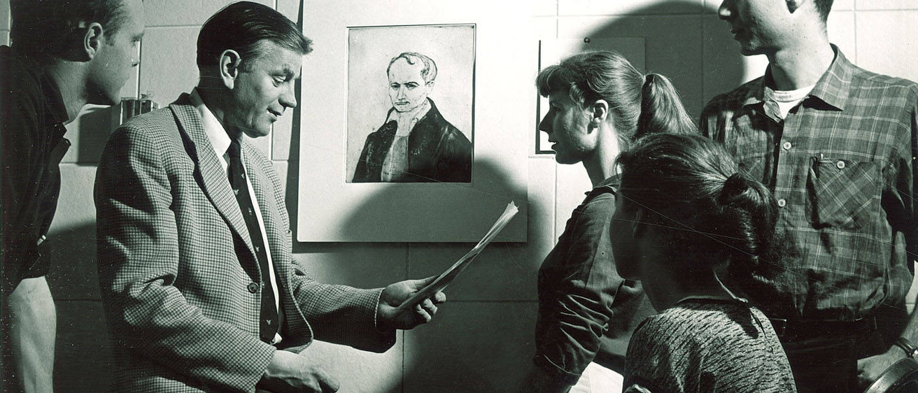 a group of people gathered in front of a drawing