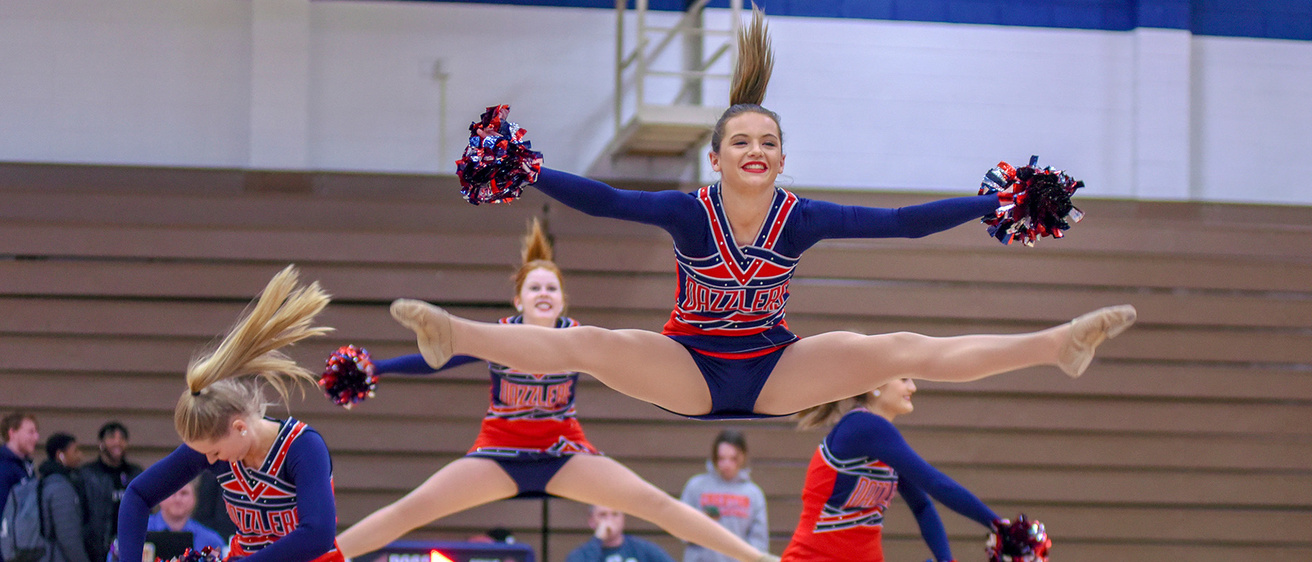 members of a dance team performing a routine in a gymnasium