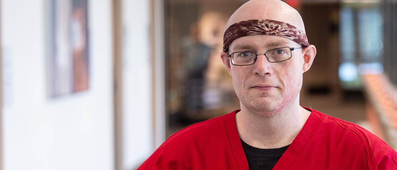 a patient care technician standing in a hallway