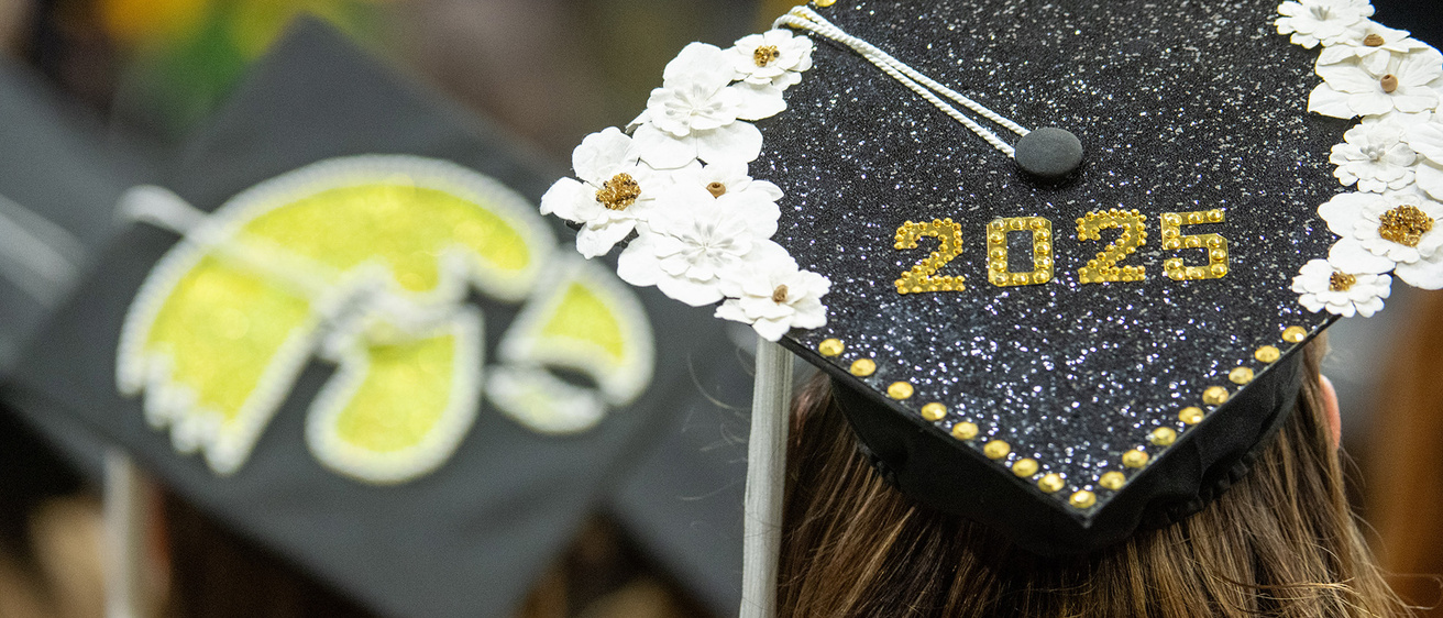 two graduation caps, one decorated with a tiger hawk and the other adorned with 2025