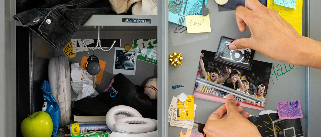 a student putting up a photo in what looks like a locker